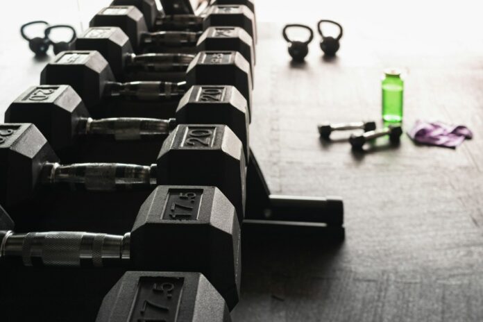 Photo by Greg Rosenke black and gray dumbbells on floor