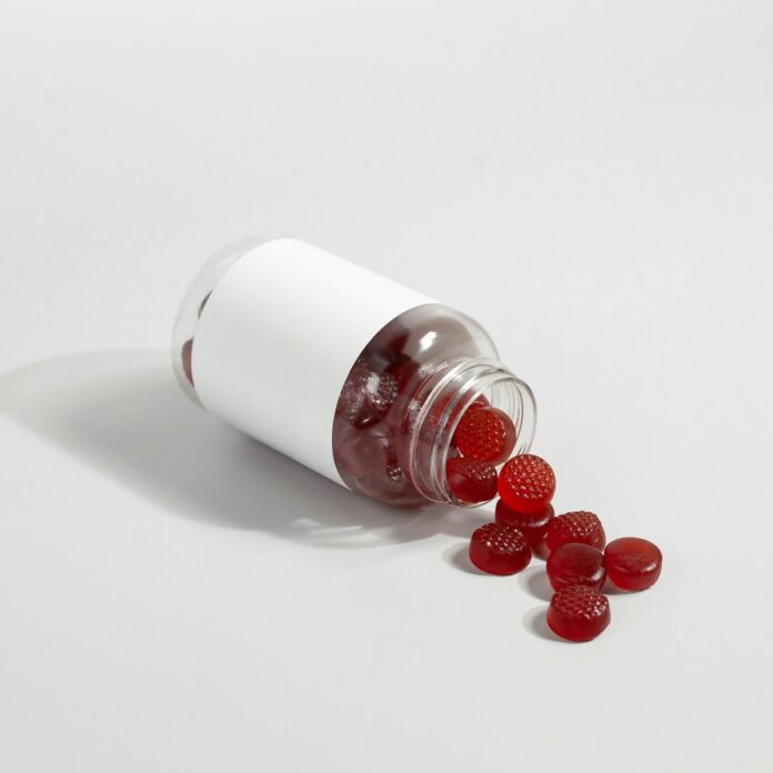 Photo by Supliful - Supplements On Demand a white salt shaker with red berries
