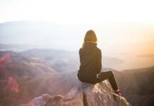 만성피로, 일상이 무너진다…원인과 극복 방법은? person sitting on top of gray rock overlooking mountain during daytime
