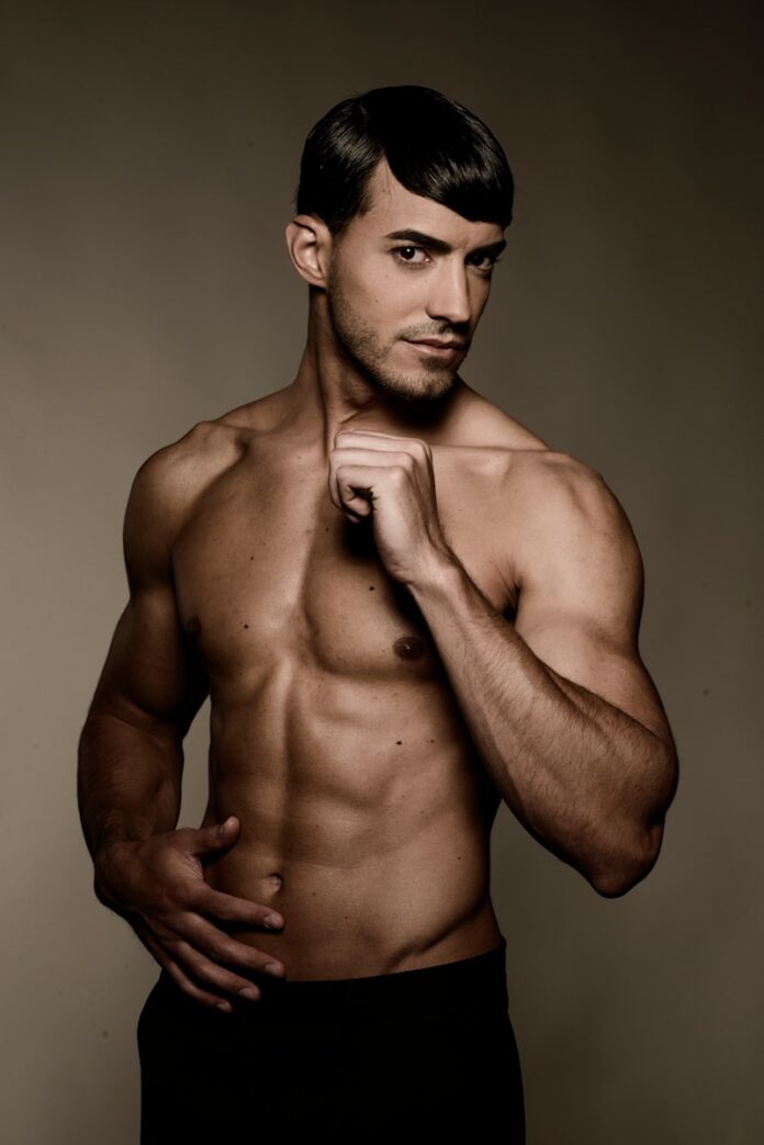 Photo by Christian Buehner topless man wearing black shorts