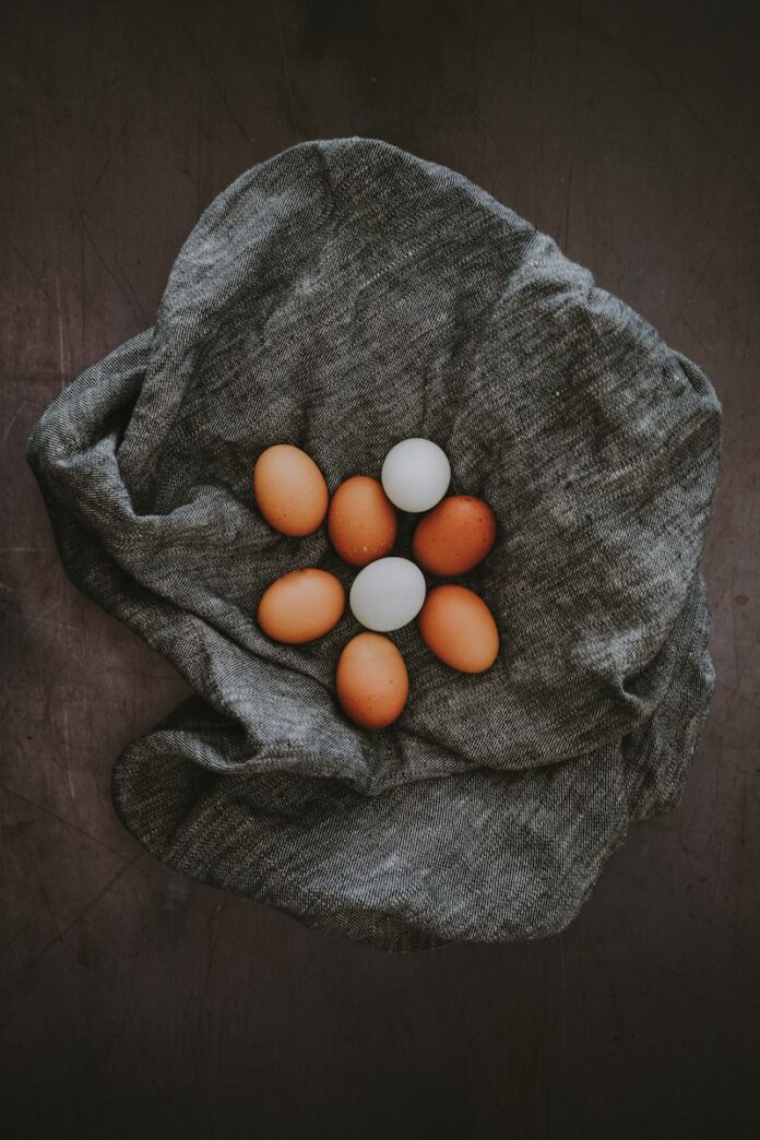 Photo by Annie Spratt white and brown egg lot on grey textile