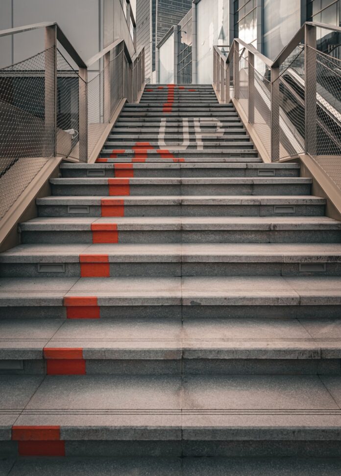 Photo by Declan Sun A set of stairs leading up to a building