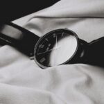 “만성피로, 일상 속 작은 변화로 극복하세요” a watch sitting on top of a white sheet