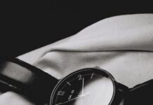 “만성피로, 일상 속 작은 변화로 극복하세요” a watch sitting on top of a white sheet