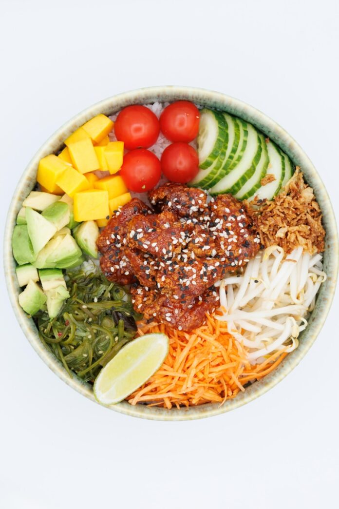 Photo by . abdelkader1001 A colorful poke bowl with fresh ingredients and chicken.