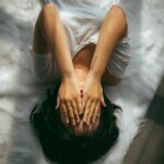 스트레스, 일상에서 가볍게 풀자…최근 뜨는 생활 속 스트레스 해소법 a woman holds her hands over her face