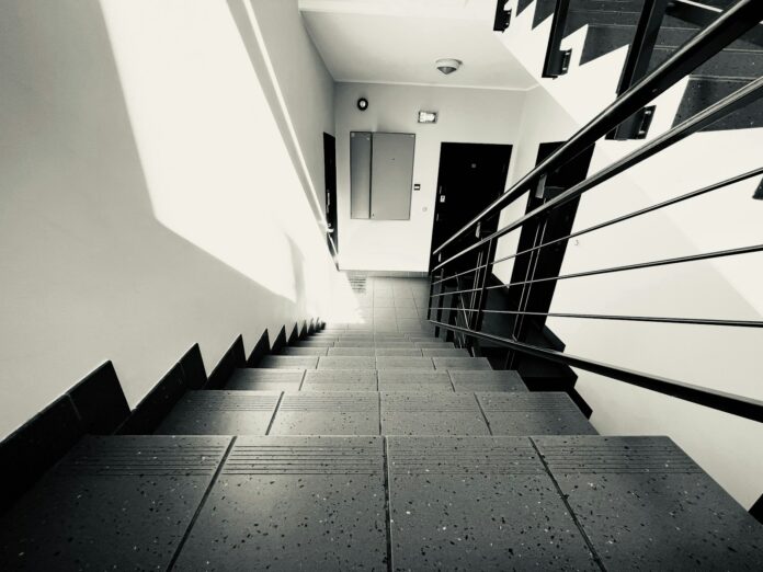 Photo by Payam Moin Afshari a black and white photo of a staircase
