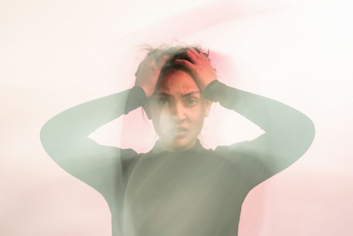 Photo by Uday Mittal woman in gray turtleneck long sleeve shirt