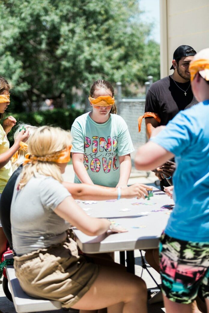 Photo by Jesus Loves Austin people gathering around table during daytime
