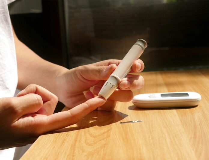 Photo by isens usa a person sitting at a table with a cell phone